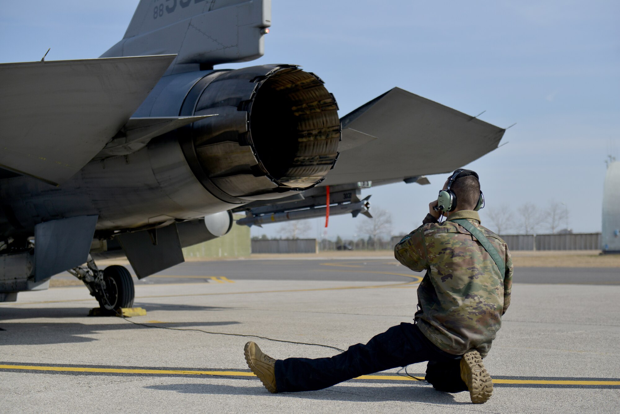U.S. Air Force Airman 1st Class Jacob Wood, 31st Aircraft Maintenance Squadron assistant dedicated crew chief, checks flight control movement on an F-16 Fighting Falcon aircraft assigned to the 555th Fighter Squadron at Aviano Air Base, Italy, Feb. 25, 2022. The flight will support NATO’s enhanced air policing mission; integrate with allies and partners in the Black Sea region in an increased defensive posture along NATO’s border and to reinforce regional security. (U.S. Air Force photo by Natalie Stanley)