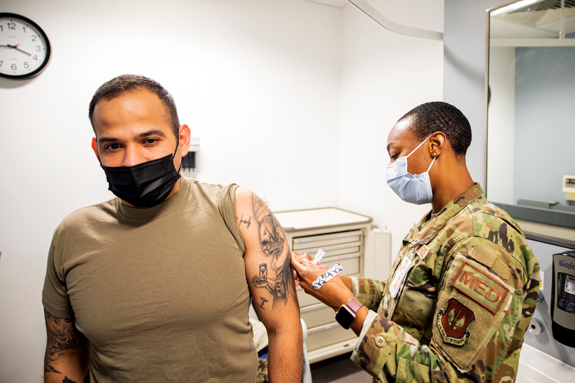 U.S. Air Force Master Sgt. Christian Navarro-Salazar, left, 423rd Security Forces Squadron supply and logistics superintendent, receives an immunization as part of his pre-deployment out-processing at RAF Alconbury, England, Feb. 24, 2022. Several SFS members are preparing to deploy in support of a joint response to conduct operations focused on bolstering the posture of NATO’s eastern flank. (U.S. Air Force photo by Senior Airman Eugene Oliver)