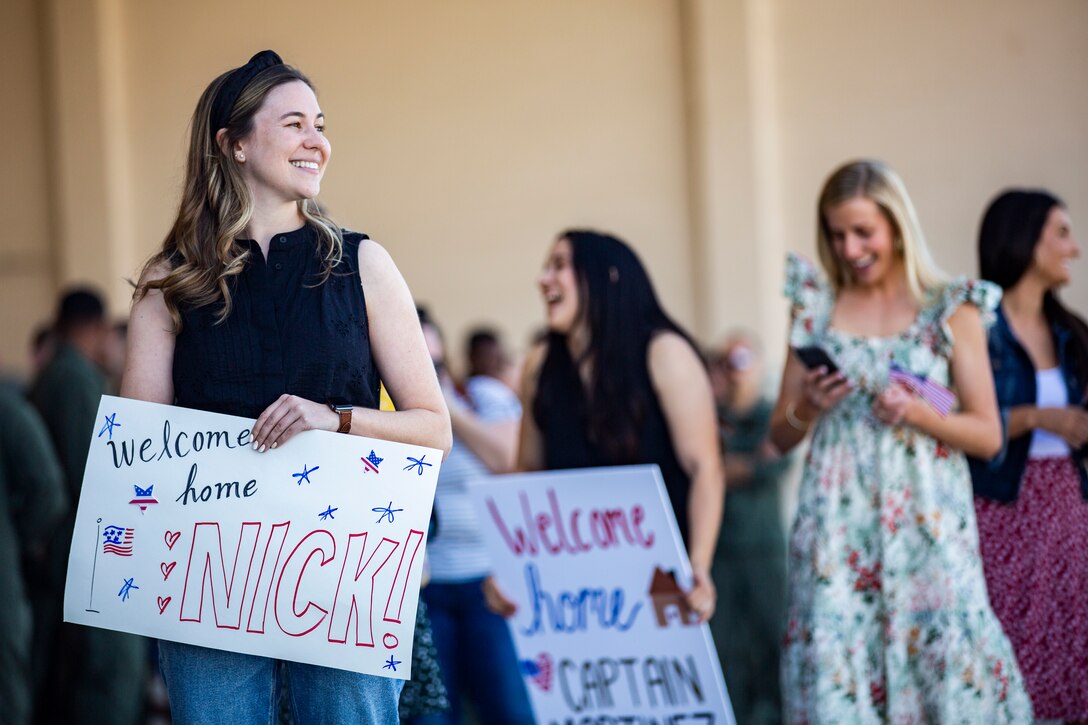 Family members await the arrival of U.S. Marines and Sailors with Marine Medium Tiltrotor Squadron (VMM) 165 (Reinforced), 11th Marine Expeditionary Unit, during a homecoming on Marine Corps Air Station Camp Pendleton, California, Feb. 28th, 2022.  The squadron returned from the unit’s Western Pacific 21.2 deployment in support of U.S. 3rd, 5th, and 7th Fleet area of operations as part of the Essex Amphibious Ready Group. 



(U.S. Marine Corps photo by Sgt. Dana Beesley)