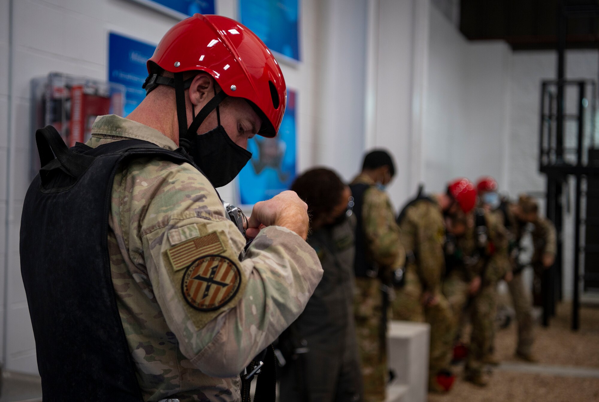 Members of the 1st Special Operations Wing fit a parachute to their body during Emergency Parachute Training, Feb. 15, 2022, at Hurlburt Field, Florida.