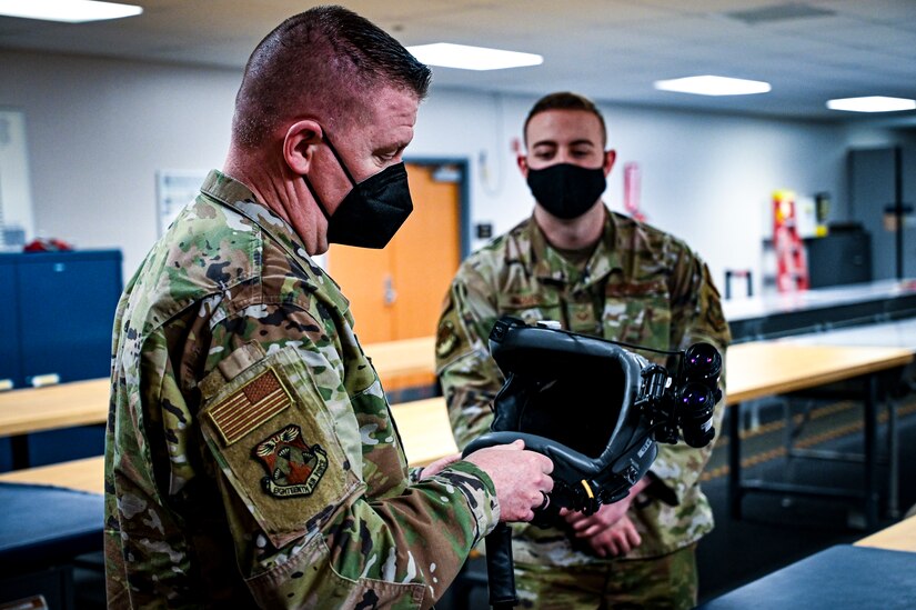 U.S. Air Force Chief Master Sgt. Chad W. Bickley, 18th Air Force, command chief, inspects a training helmet on Feb. 24, 2022, at Joint Base McGuire-Dix-Lakehurst, N.J. Bickley visited the 305 Air Mobility Wing to learn how the unit contributes to the 18th Air Force airlift and aerial refueling missions, and spoke with Airmen to learn about their successes and challenges. As Air Mobility Command’s sole numbered Air Force, 18th AF is tasked with presenting trained, equipped, and ready forces for worldwide operational requirements.