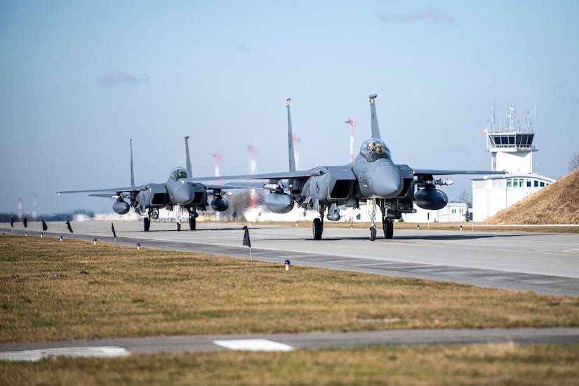 Jets line up on a runway.