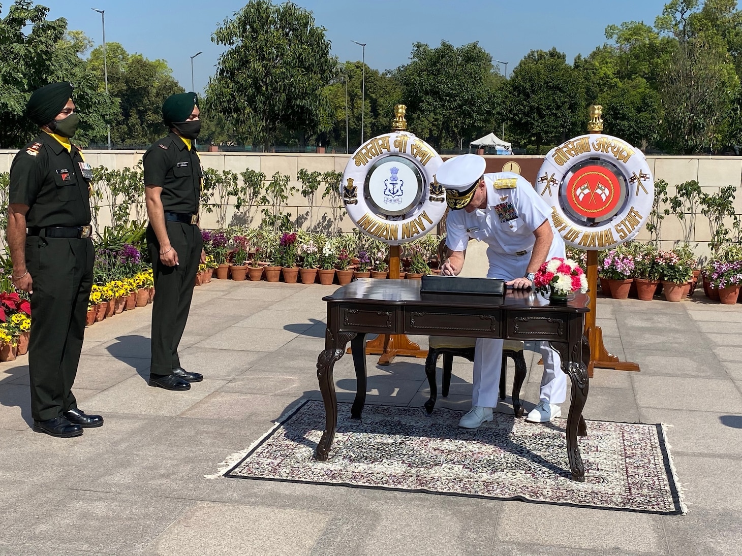 Adm. Samuel Paparo, commander, U.S. Pacific Fleet, signs a guest book to memorialize his participation in a wreath laying at the National War Memorial in New Delhi.