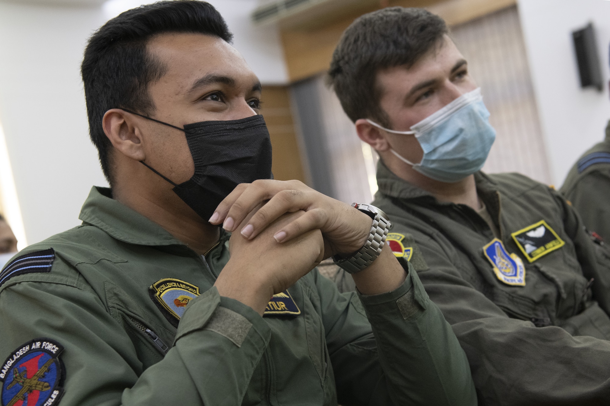 Flight Lieutenant Rashman Atiur, left, Bangladesh air force (BAF) pilot, and 1st Lt Connor Armfield, right, 36th Expeditionary Airlift Squadron C-130J Super Hercules pilot, listen to a briefing focused on C-130 capabilities during a subject matter exchange event as part of Exercise Cope South 2022, Feb. 19, 2022, at BAF Base Bangabandhu, Bangladesh. Discussions during the SME event also included best practices on low level flight, aircrew flight equipment nomenclature and crew resource management. Exercise Cope South is a Pacific Air Forces-sponsored bilateral tactical airlift exercise designed to enhance the interoperability between the U.S. Air Force and BAF. (U.S. Air Force photo by Tech. Sgt. Christopher Hubenthal)