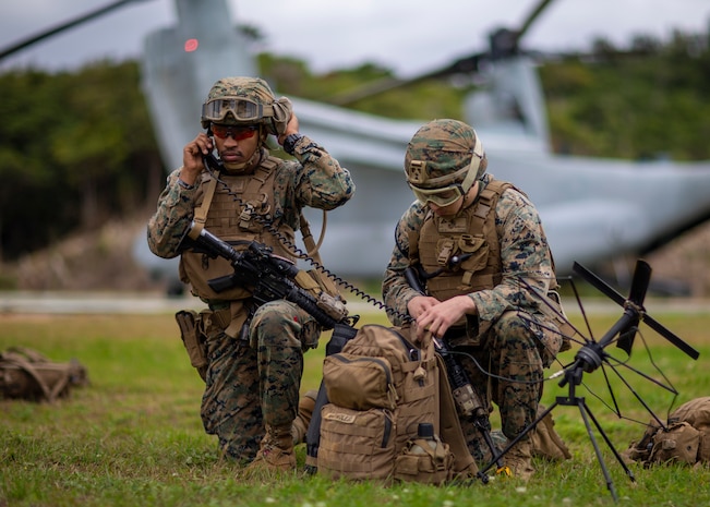 U.S. Marine Corps Lt. Collin Bish, landing support and air delivery officer in charge, 31st Marine Expeditionary Unit (MEU) and Lance Cpl. Angel D. Marmolejo, a transmission system operator with Combat Logistics Battalion 31, 31st MEU, establish a communications network while participating in mass casualty response training on Ie Shima, Feb. 10, 2022.