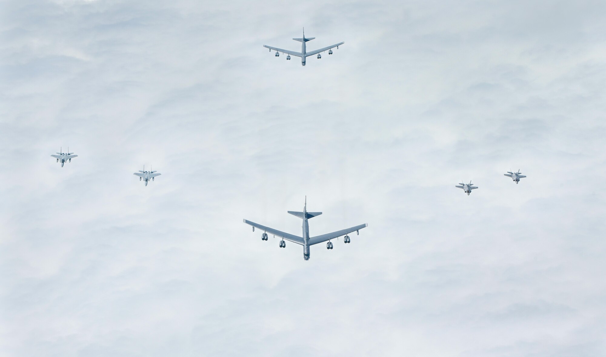 Two Japan Air Self-Defense Force F-15MJs, two U.S. Air Force B-52s Stratofortresses and two U.S. Air Force F-35A Lightning IIs fly in a joint formation