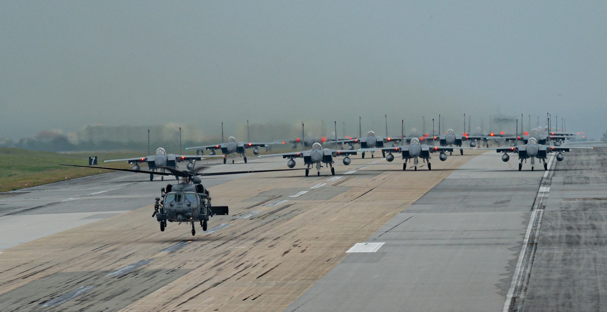 A formation of F-15C/D Eagles assigned to the 44th and 67th Fighter Squadrons, a KC-135 Stratotanker assigned to the 909th Air Refueling Squadron, an E-3 Sentry assigned to the 961st Airborne Air Control Squadron, and an HH-60 Pavehawk assigned to the 33rd Rescue Squadron taxi during a routine wing readiness exercise at Kadena Air Base