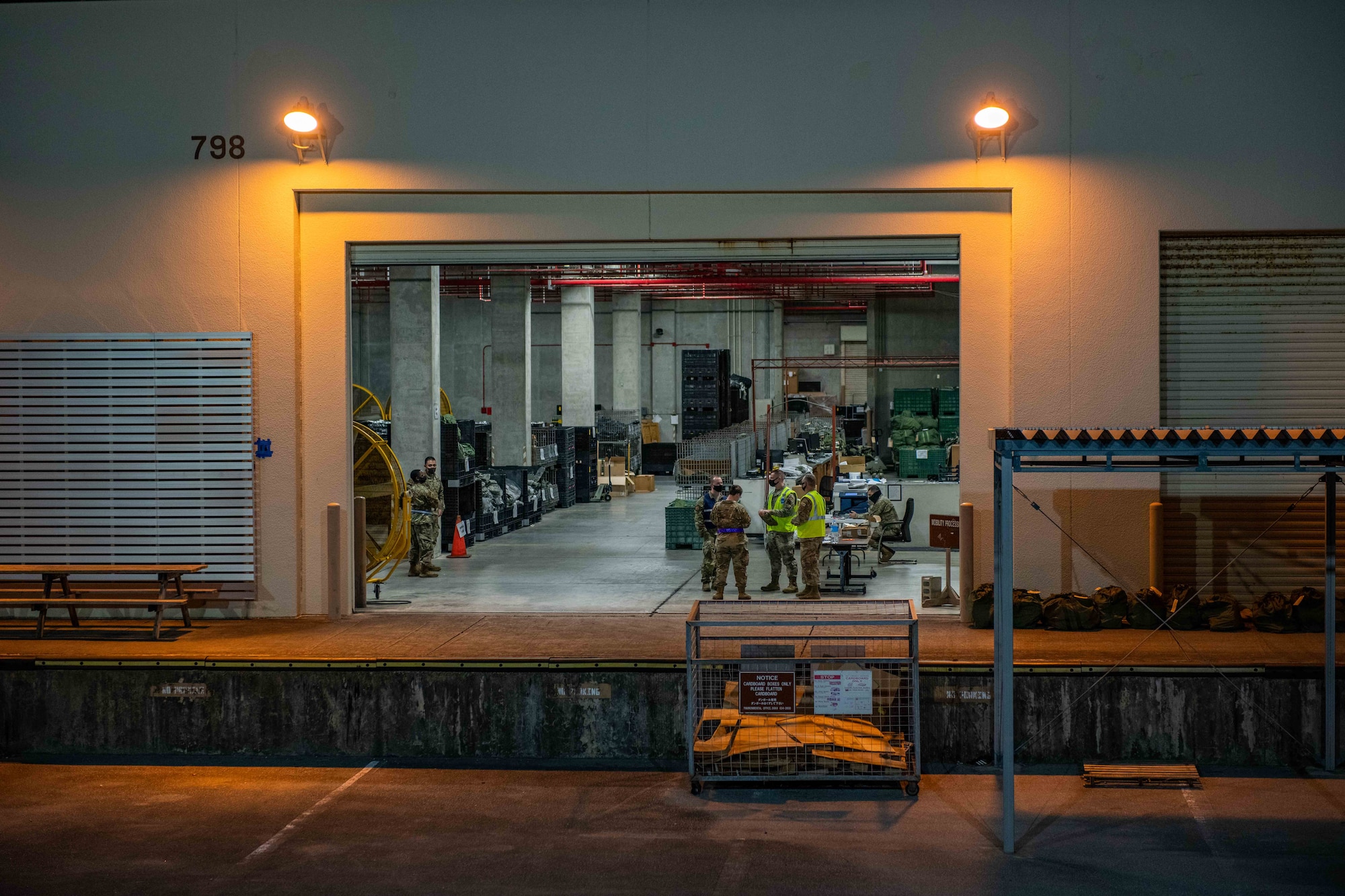A warehouse door stays open in the night