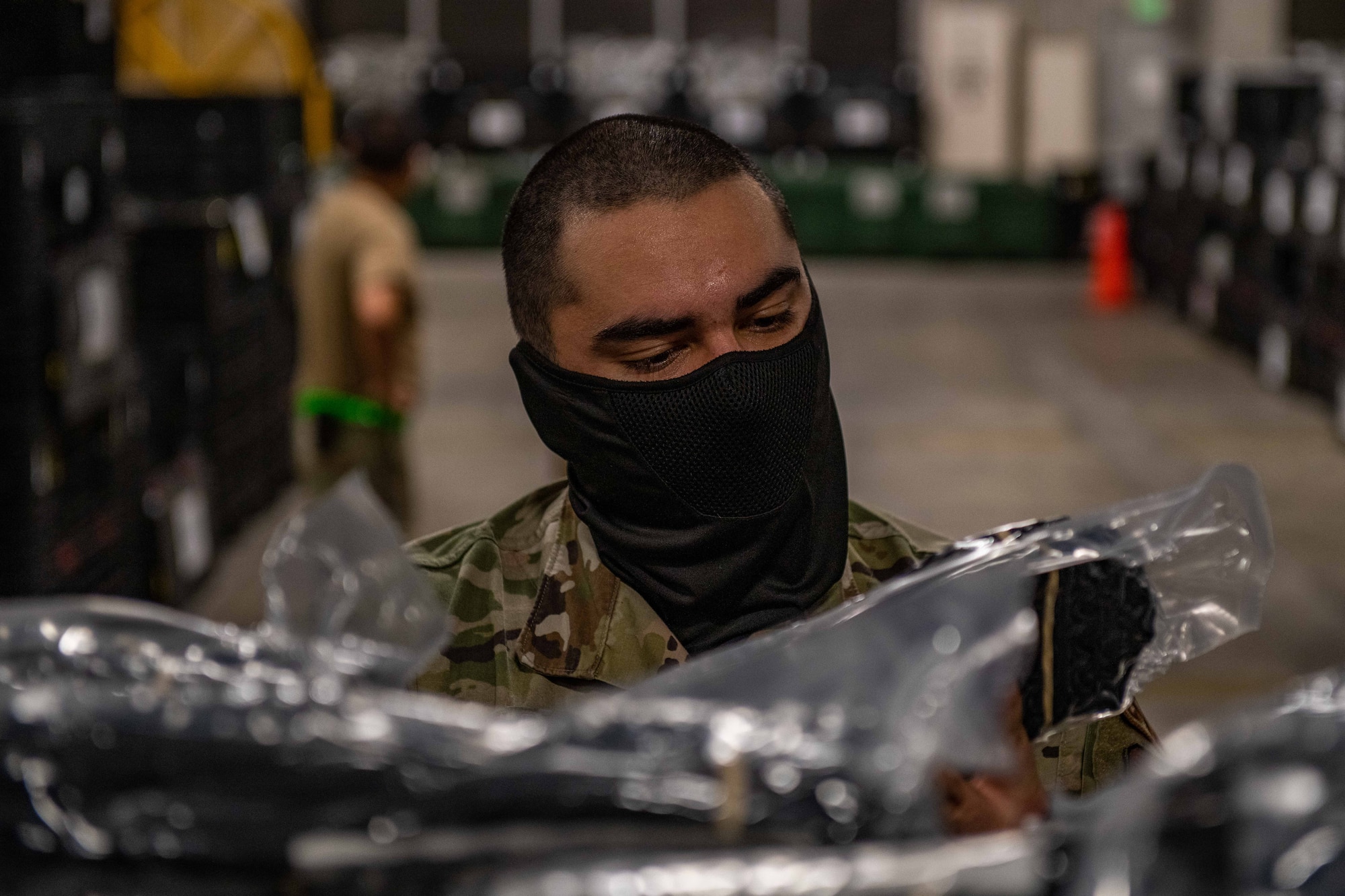 An Airman inspects boots