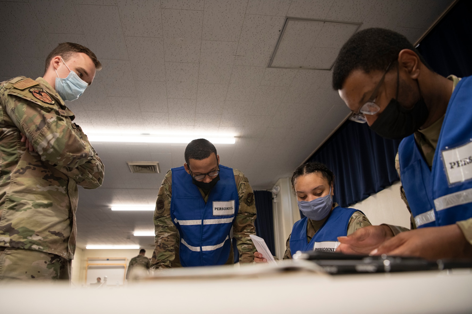 Airmen look over documentation at a briefing.