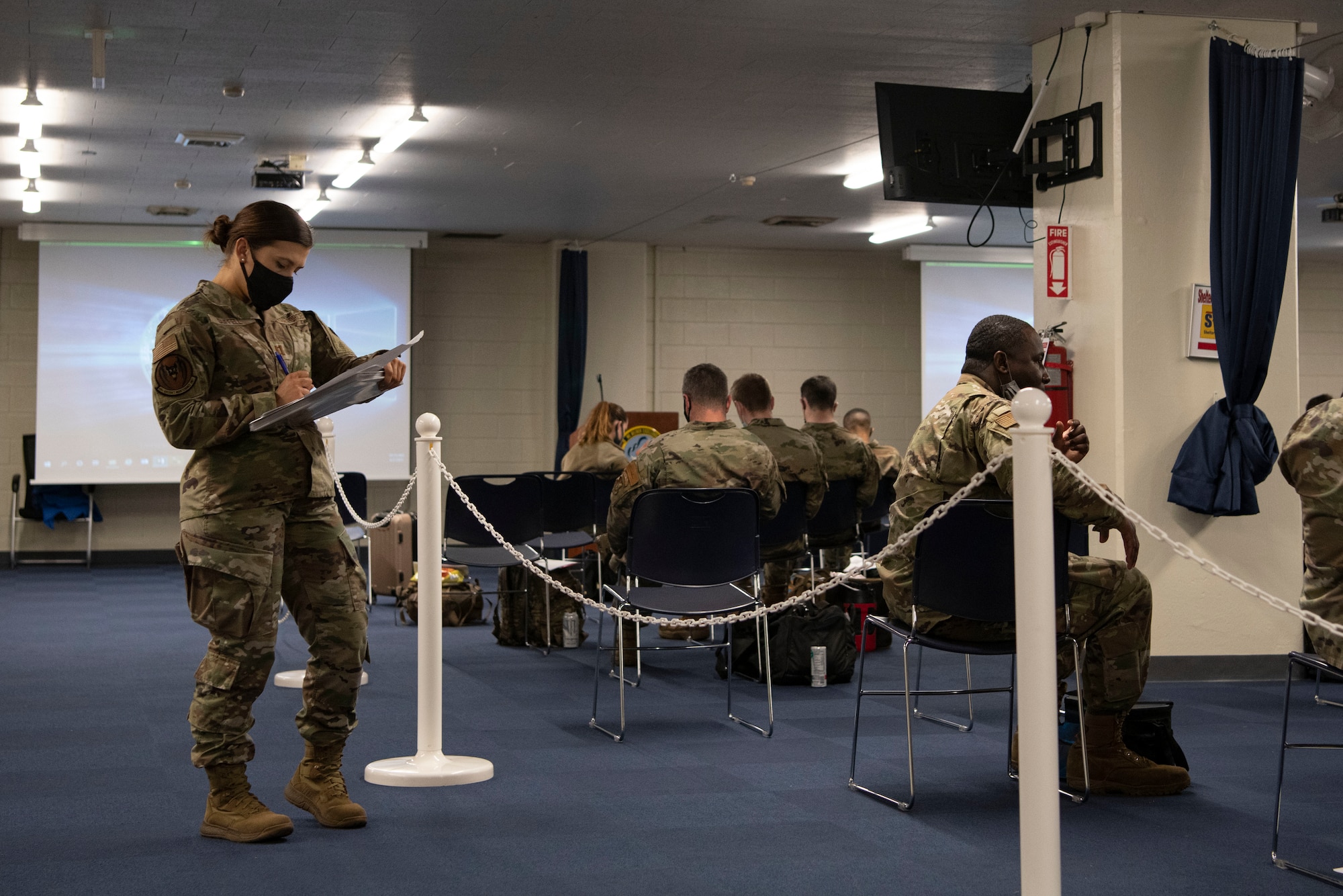 An airman takes attendance at a briefing