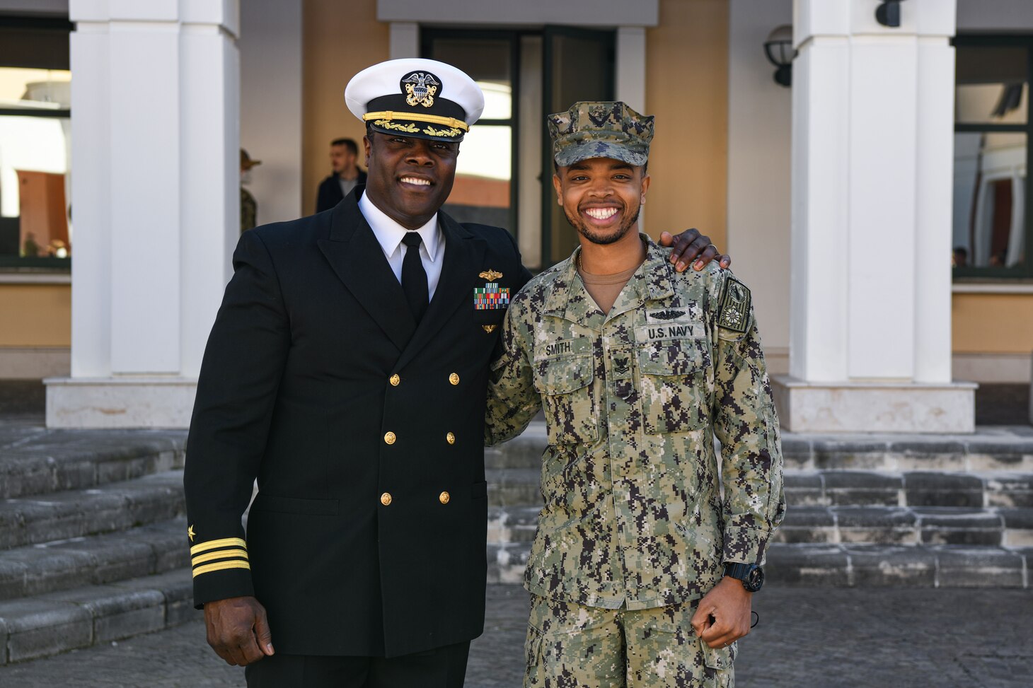 Cmdr. Hasan AbdulMutakallim, left, and Yeoman 2nd Class Danny Smith, right, pose for a photo during a Black History Month event at Naval Support Activity Naples, Italy, Feb. 24, 2022.