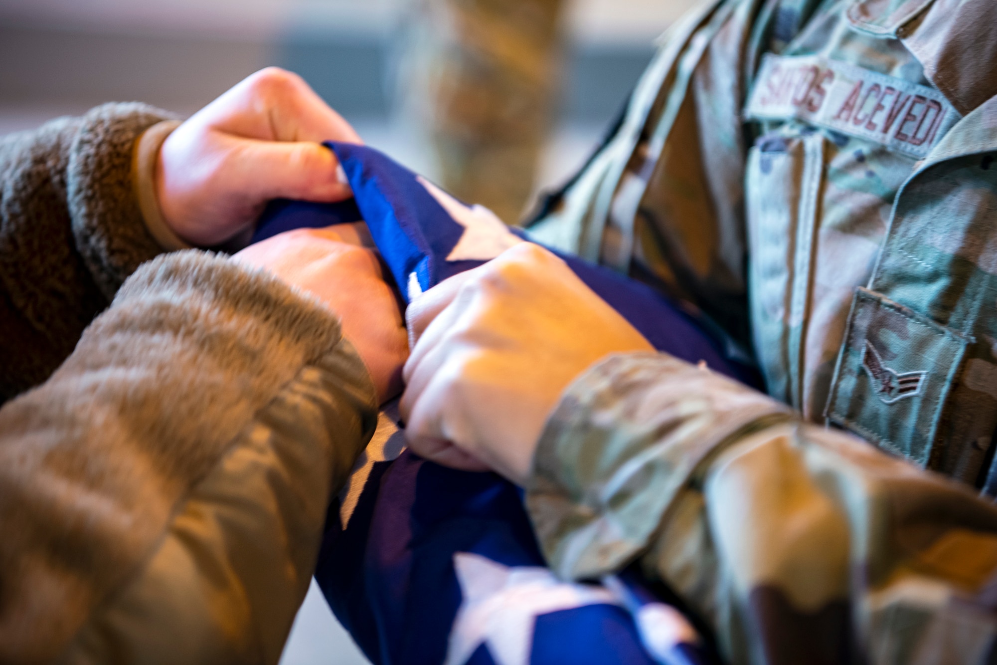 An Airman from the 423rd Air Base Group honor guard, folds a flag at RAF Alconbury, England, Feb. 9, 2022. Airmen from the 423 Air Base Group honor guard conduct weekly training sessions to hone their skills and build chemistry in executing details with Airmen from different squadrons. (U.S. Air Force photo by Senior Airman Eugene Oliver)