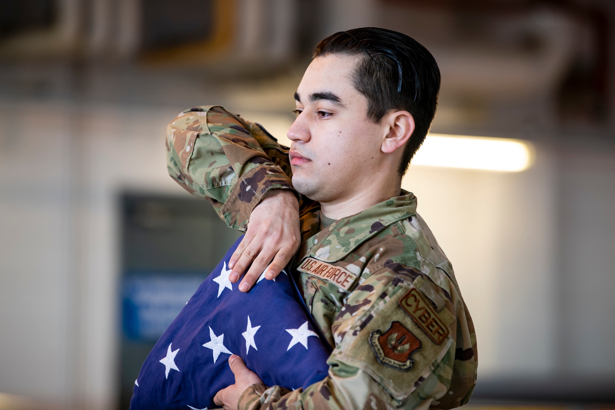 U.S. Air Force Airman Francisco Ruiz, 423rd Communications Squadron client systems apprentice, dresses a flag at RAF Alconbury, England, Feb. 9, 2022. Airmen from the 423rd Air Base Group honor guard conduct weekly training sessions to hone their skills and build chemistry in executing details with Airmen from different squadrons. (U.S. Air Force photo by Senior Airman Eugene Oliver)