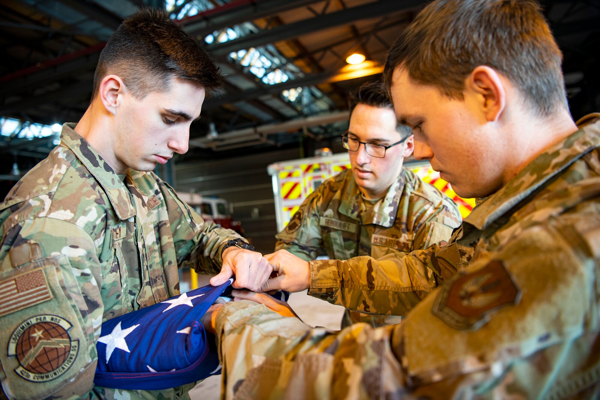 U.S. Air Force Airmen from the 423rd Air Base Group honor guard, fold a flag at RAF Alconbury, England, Feb. 9, 2022. Airmen from the 423 Air Base Group honor guard conduct weekly training sessions to hone their skills and build chemistry in executingdetails with Airmen from different squadrons. (U.S. Air Force photo by Senior Airman Eugene Oliver)
