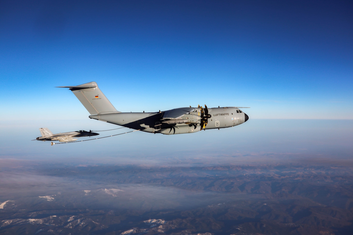 A German Air Force A400M Tanker refuels an F/A-18E Super Hornet, attached to the “Fighting Checkmates” of Strike Fighter Squadron (VFA) 211, Feb. 25, 2022.