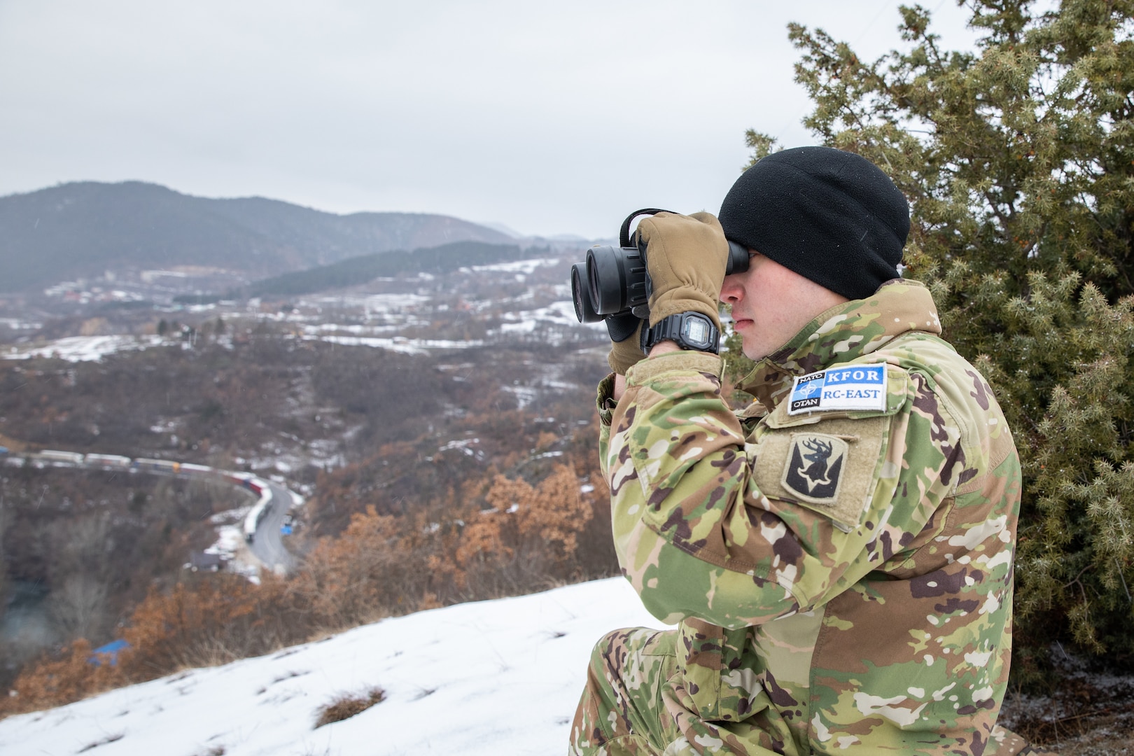 U.S. Army Spc. Timothy Clark, Alpha Troop, 1st Squadron, 172nd Cavalry Regiment Mountain, Maneuver Battalion, Kosovo Force Regional Command-East, patrols near Gate 1 Jarinje in Kosovo, Feb. 3, 2022. These scouts observe, document, and report activities along main roads and established bypass routes. Commanders use scout data to inform decisions and plan future missions which support a safe and secure environment for all people of Kosovo. (U.S. Army photo by Staff Sgt. Barbara Pendl)