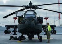 A U.S. Army Soldier assigned to 1-3rd Attack Battalion, 12th Combat Aviation Brigade, executes preventive maintenance daily (PMD) on an AH-64D Apache Longbow helicopter at Lielvarde Military Airfield, Latvia, Feb. 24, 2022. Elements of the 12 CAB departed Germany for Lithuania and Latvia to conduct training with NATO allies in support of Saber Strike 22. 12 CAB trains and remains a constant and credible U.S. Army aviation force in support of allies and partners and the stability and security of Europe. (U.S. Army photo by Staff Sgt. Thomas Mort)