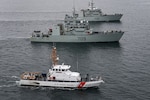 Coast Guard Cutter Blue Shark transits the waters of the Salish Sea alongside HMCS Saskatoon and HMCS Yellowknife during a joint exercise on Feb. 17, 2022. The exercise was conducted to train and prepare Royal Canadian navy crews for deployments to support United States counter-narcotics operations. (U.S. Coast Guard photo by Petty Officer 2nd Class Steve Strohmaier)