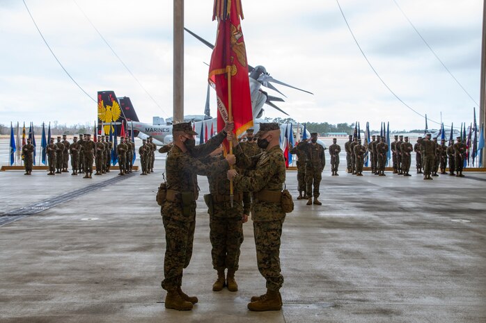 U.S. Marine Corps Lt. Col. Larry L. Buzzard, (left), and Lt. Col. Kenneth K. Rossman exchange squadron colors during a change of command ceremony for Marine Medium Tiltrotor Squadron (VMM) 162 at Marine Corps Air Station New River, North Carolina, Feb. 3, 2022.