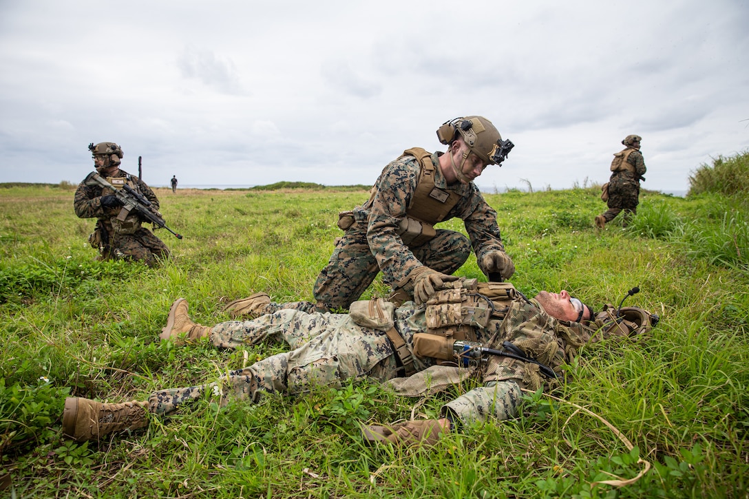 A U.S. Marine with Battalion Landing Team 1/5, 31st Marine Expeditionary Unit, searches the simulated enemy during a helicopter raid training exercise on Ie Shima, Okinawa, Japan, Feb. 9, 2022. The training exercise consisted of Marines taking control of a known location to establish a Forward Arming and Refueling Point. The 31st MEU is operating aboard ships of Amphibious Ready Group in the 7th fleet area of operations to enhance interoperability with allies and partners and serve as a ready response force to defend peace and stability in the Indo-Pacific region.
