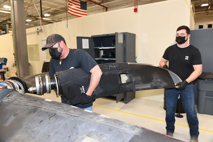 Aircraft Mechanics holding propeller