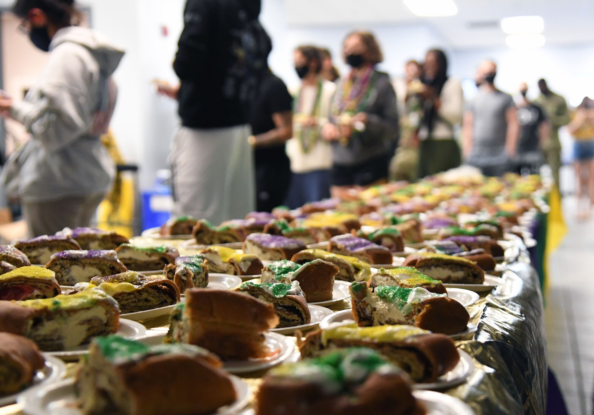 King cake slices are displayed for 81st Training Group Airmen inside the Levitow Training Support Facility at Keesler Air Force Base, Mississippi, March 1, 2022. The event, hosted by the 81st Training Wing chaplains office, was in celebration of Mardi Gras and also provided gumbo. (U.S. Air Force photo by Kemberly Groue)