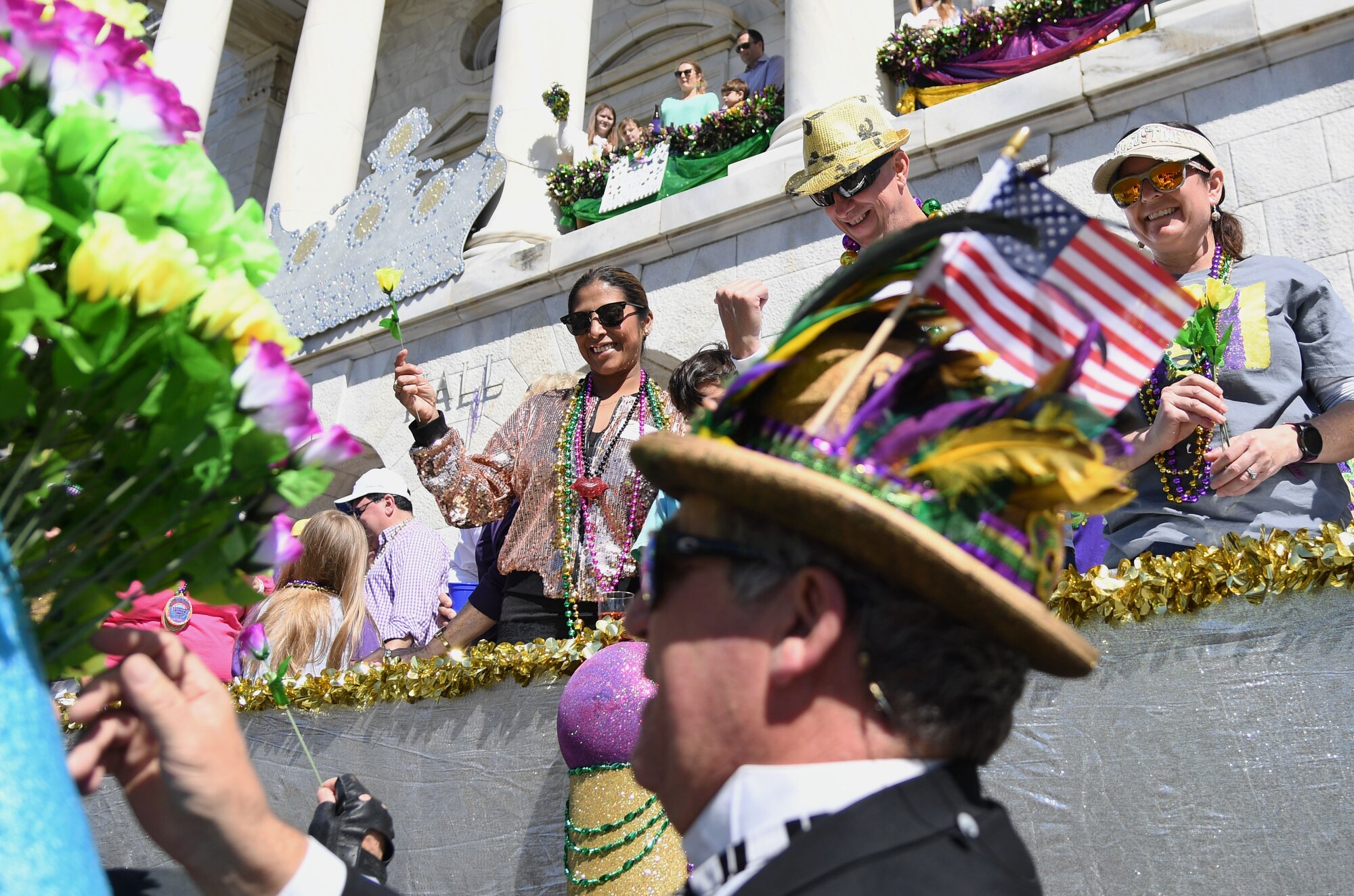 U.S. Air Force Col. William Hunter, 81st Training Wing commander, his wife, Blanca, and Chief Master Sgt. Barbara Gilmore, 403rd Wing command chief, attend the Gulf Coast Carnival Association Mardi Gras parade in Biloxi, Mississippi, March 1, 2022. Keesler personnel participate in local parades every Mardi Gras season to show their support of the communities surrounding the installation. (U.S. Air Force photo by Kemberly Groue)