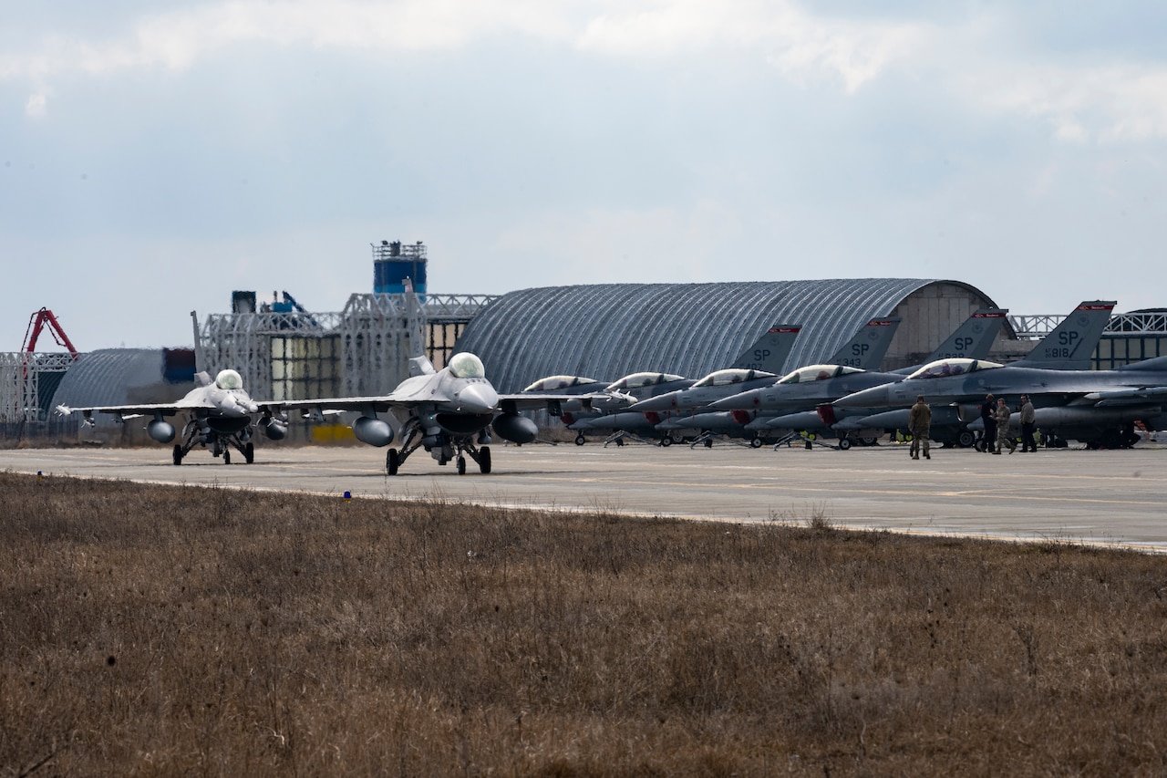 Jets line up on runway.