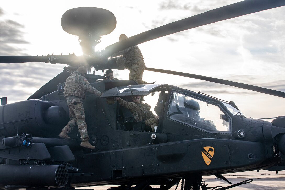 Soldiers work on a helicopter.
