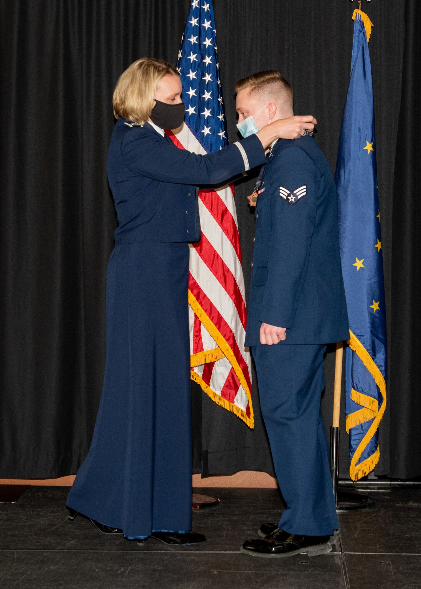 An Airman is presented with a medallion.
