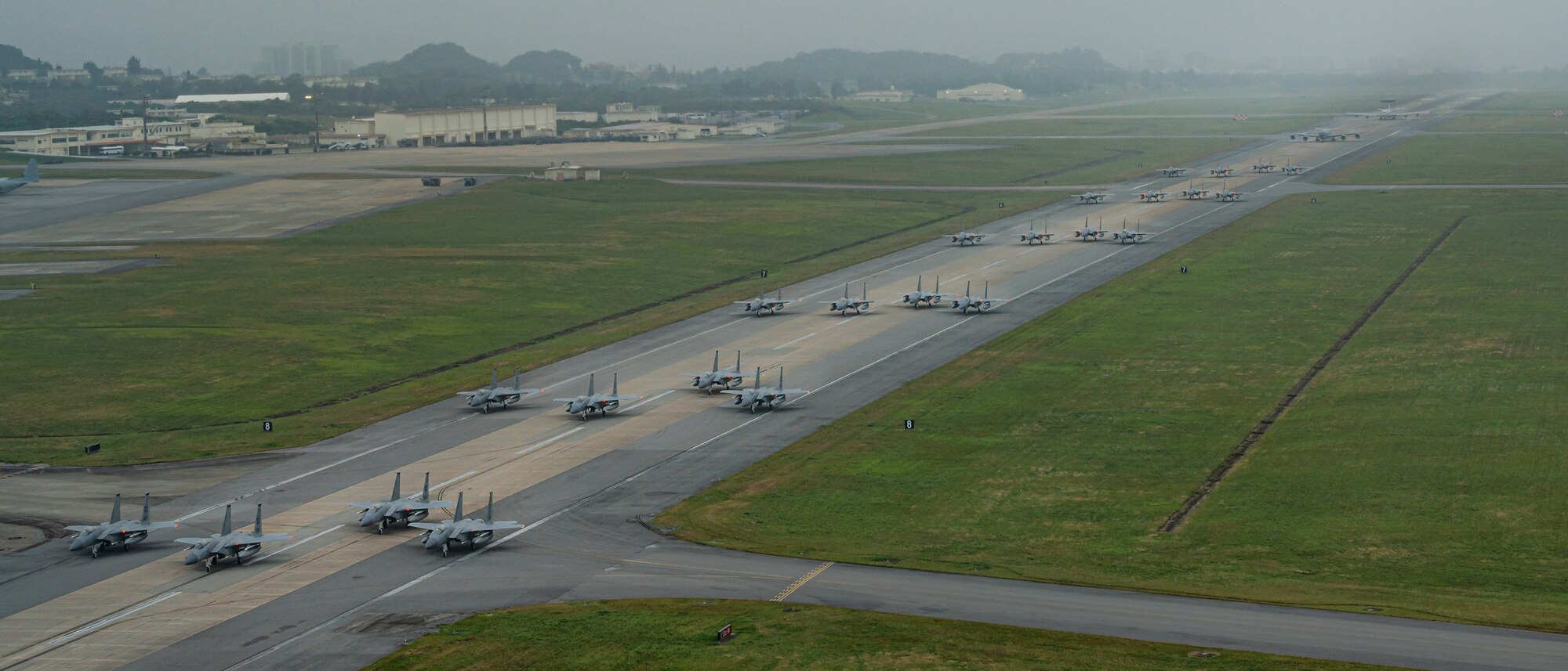 A formation of F-15C/D Eagles assigned to the 44th and 67th Fighter Squadrons, a KC-135 Stratotanker assigned to the 909th Air Refueling Squadron, and an E-3 Sentry assigned to the 961st Airborne Air Control Squadron taxi during a routine wing readiness exercise at Kadena Air Base