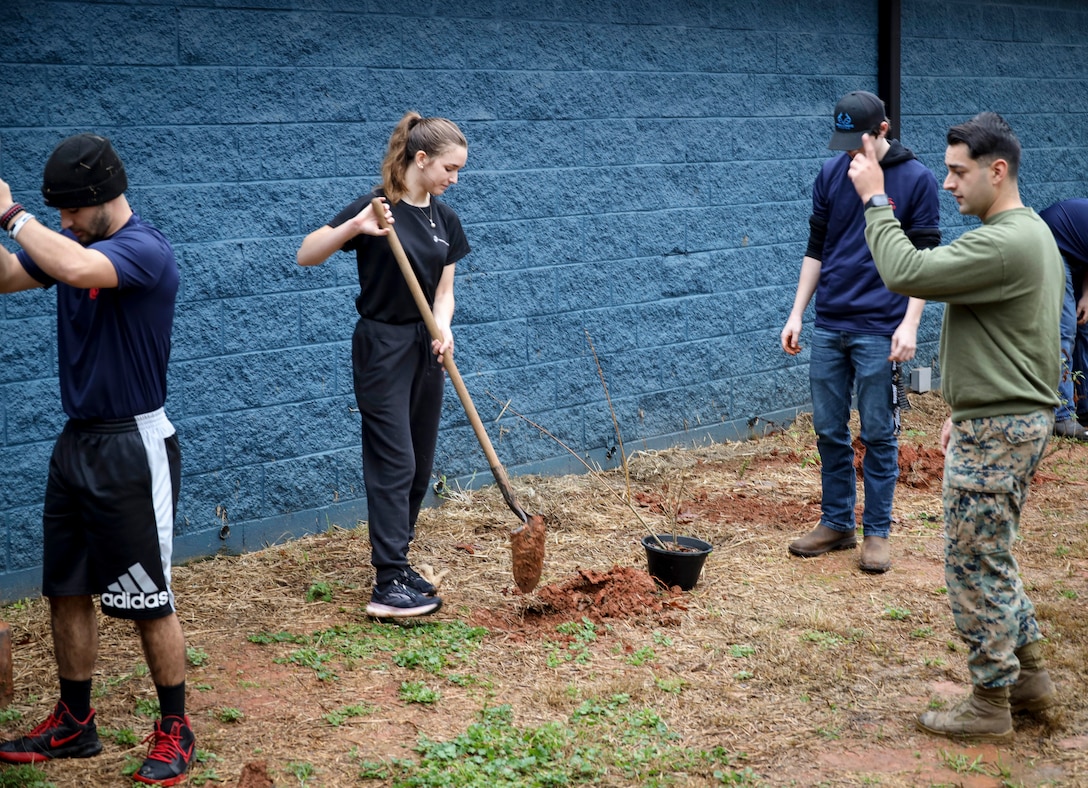 U.S. Marine Corps Staff Sgt. Richard Gastelum, a recruiter with Recruiting Sub Station Athens, Recruiting Station Columbia, helps poolees plant trees outside of the Oconee County Animal Shelter, Athens, Georgia on Nov. 13, 2021. The Marines and Poolees from RSS Athens volunteered at the animal shelter to help clean kennels, lay mulch, plant trees and pave trails, for the animals being cared for. (U.S. Marine Corps photo by Cpl. Dylan Walters)