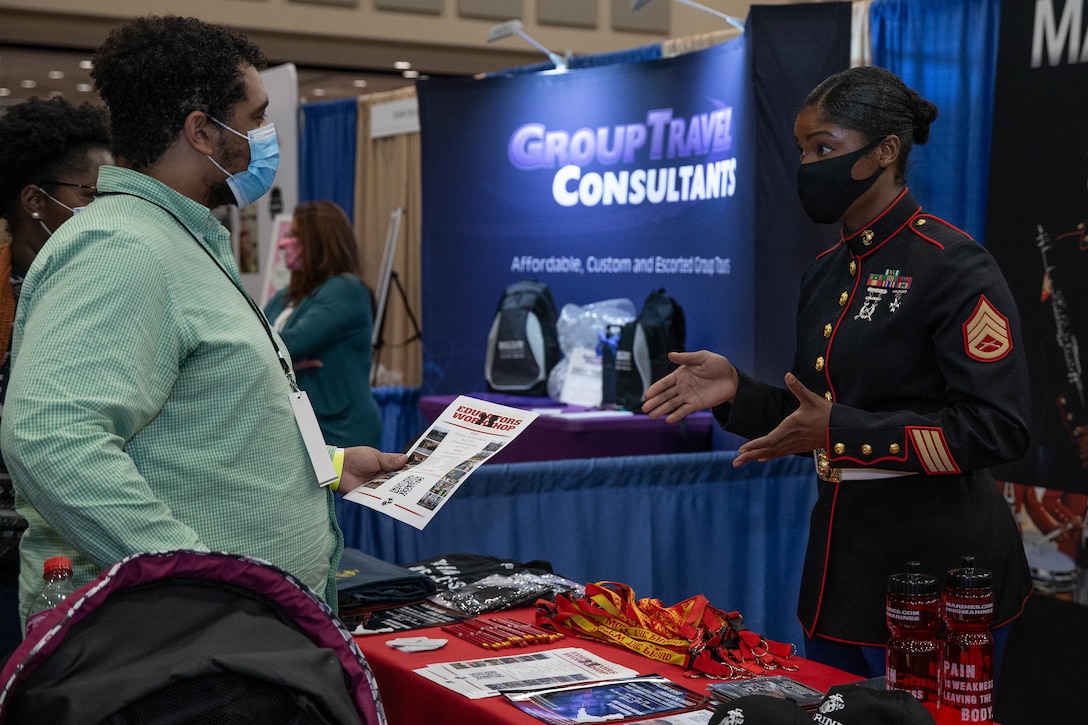 U.S. Marine Corps Staff Sgt. Mardia A. Timoney, 6th Marine Corps District's Musician Technical Assistant, answers attendee's questions regarding the Marine Corps Enlistment Option Program and Educators Workshop during the Georgia Music Educators Association held at the Classic Center, Athens, Georgia, Jan. 27, 2022. The GMEA's mission is to promote the advancement of music education in the state of Georgia. (U.S. Marine Corps photo by Lance Cpl. Kevin Lopez Herrera)