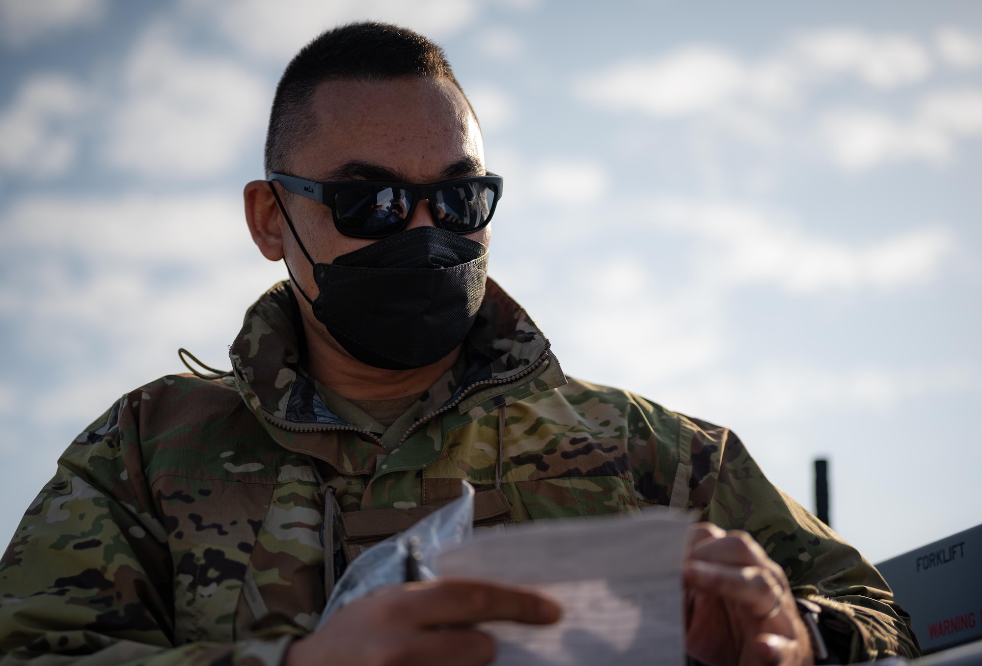 Airman reviews paper.