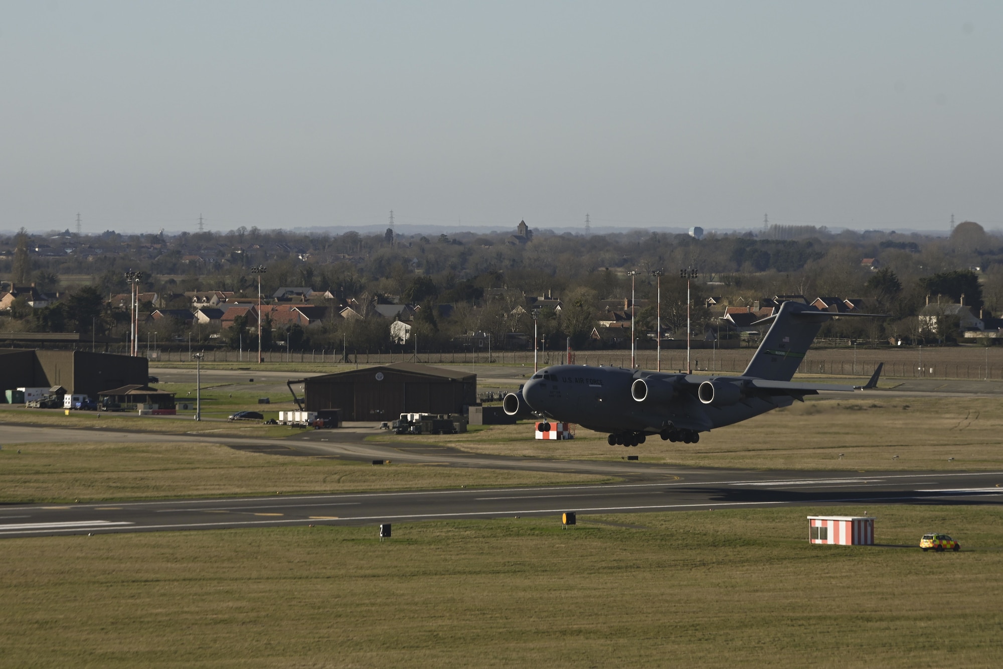 A U.S. Air Force C-17 Globemaster III aircraft assigned to the 62nd Airlift Wing, Joint Base Lewis-McChord, Wash., approaches the runway to land at Royal Air Force Mildenhall, England, Feb. 27, 2022. The aircraft landed at RAF Mildenhall after transporting cargo pallets to an air base in Norway. (U.S. Air Force photo by Senior Airman Joseph Barron)