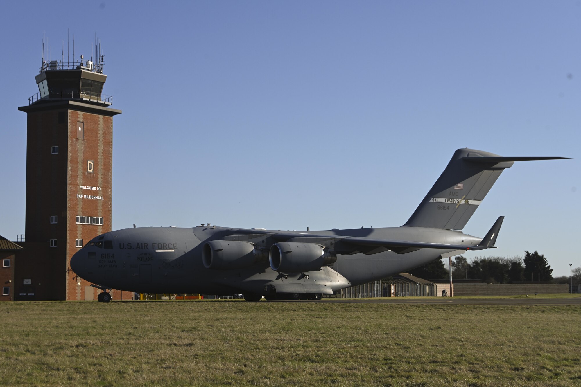 A U.S. Air Force C-17 Globemaster III aircraft assigned to the 60th Air Mobility Wing, Travis Air Force Base, Calif., taxis along the flightline after landing at Royal Air Force Mildenhall, England, Feb. 27, 2022. The aircraft landed at RAF Mildenhall after transporting cargo pallets to an air base in Norway. (U.S. Air Force photo by Senior Airman Joseph Barron)