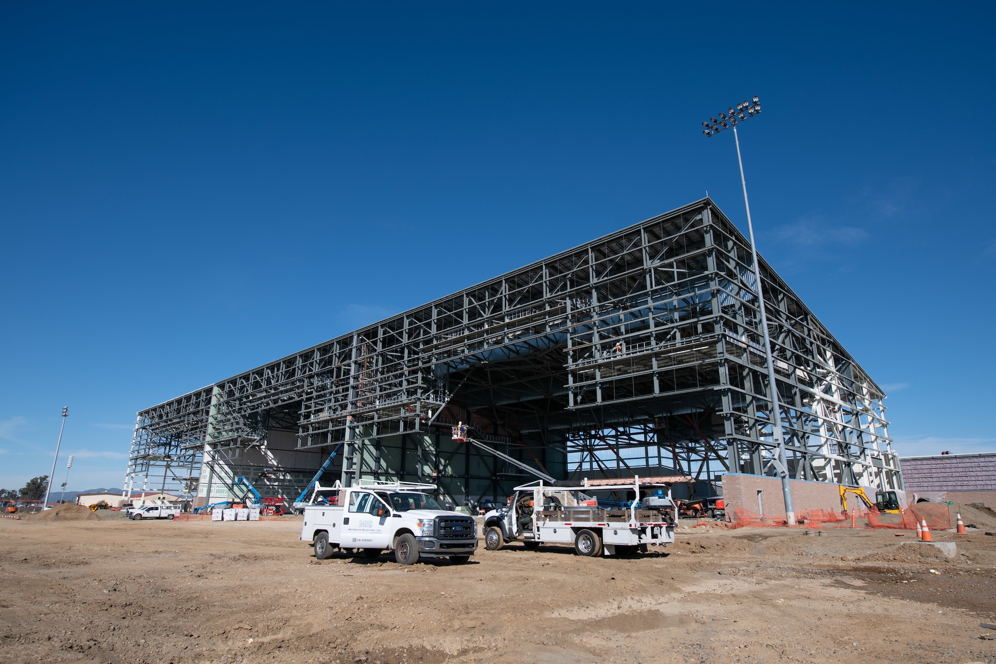 Walsh Construction crewmen install insulated wall panels during construction of the KC-46A Pegasus 3-bay maintenance hangar
