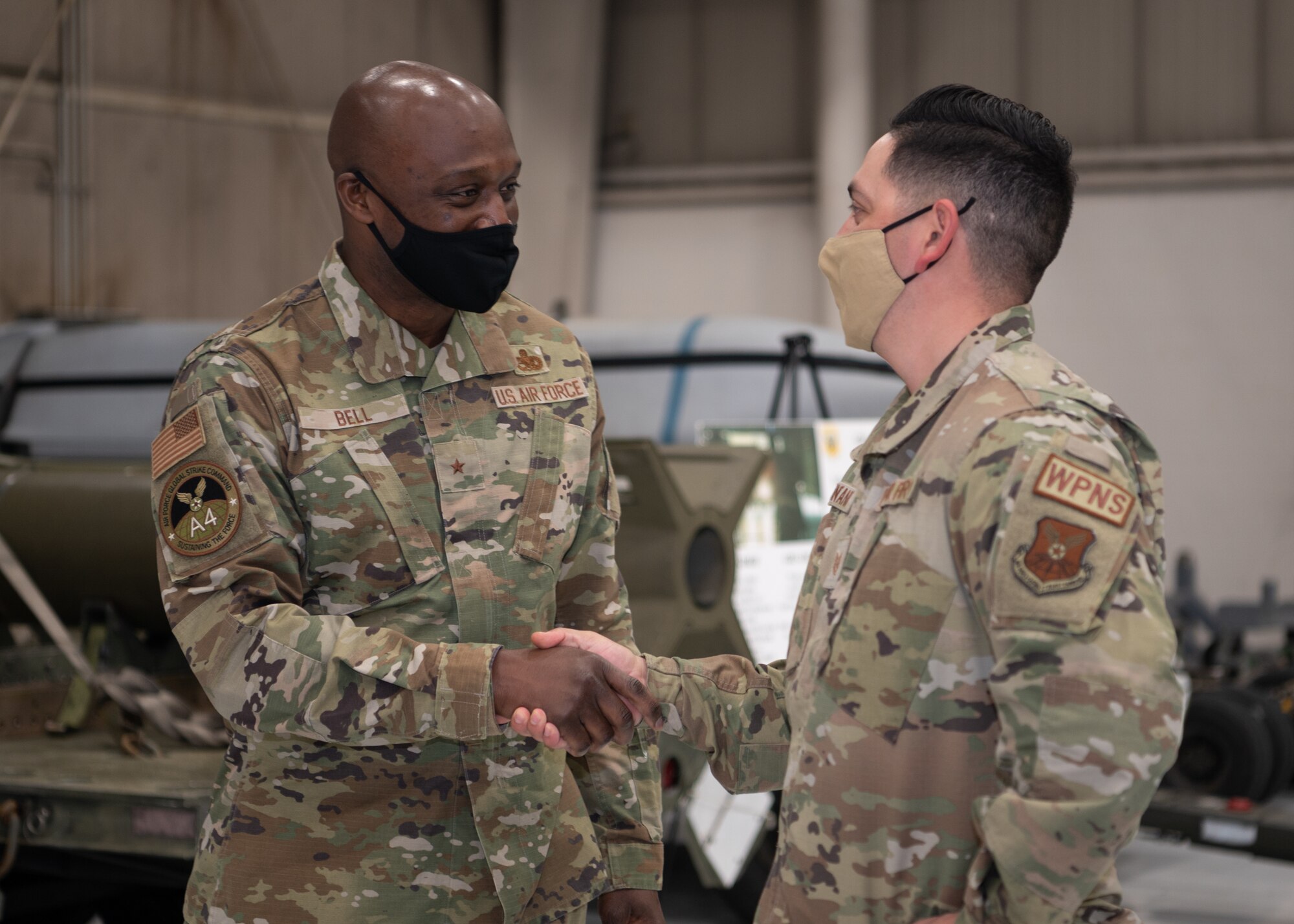 Brig. Gen. Kenyon Bell shakes hands with Tech. Sgt. Phillip Montano.