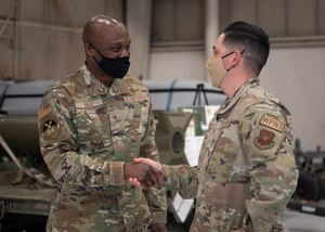 Brig. Gen. Kenyon Bell shakes hands with Tech. Sgt. Phillip Montano.
