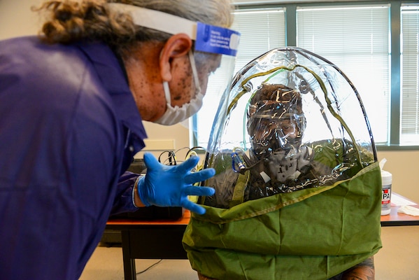 FORT WORTH, Texas (Feb. 16, 2022) - Joint Service Mask Leakage Tester Arnie Perez, left, performs a fit test of the M-50 gas mask for Navy Reserve Yeoman 1st Class Andre Polk, assigned to Navy Reserve Center New York City, at Navy Reserve Region Readiness and Mobilization Command Fort Worth (REDCOM FW), in preparation for Polk’s scheduled mobilization to Qatar. Selected Reserve mobilization processing for Polk and other Sailors took place during an adaptive mobilization-enabling event at REDCOM FW February 14-18. The event was observed by assessors from Expeditionary Combat Readiness Center, who certified REDCOM FW as a Navy mobilization processing site with delegated Local Area Coordinator for Mobilization (LACMOB) authority. (U.S. Navy photo by Mass Communication Specialist 1st Class Lawrence Davis)