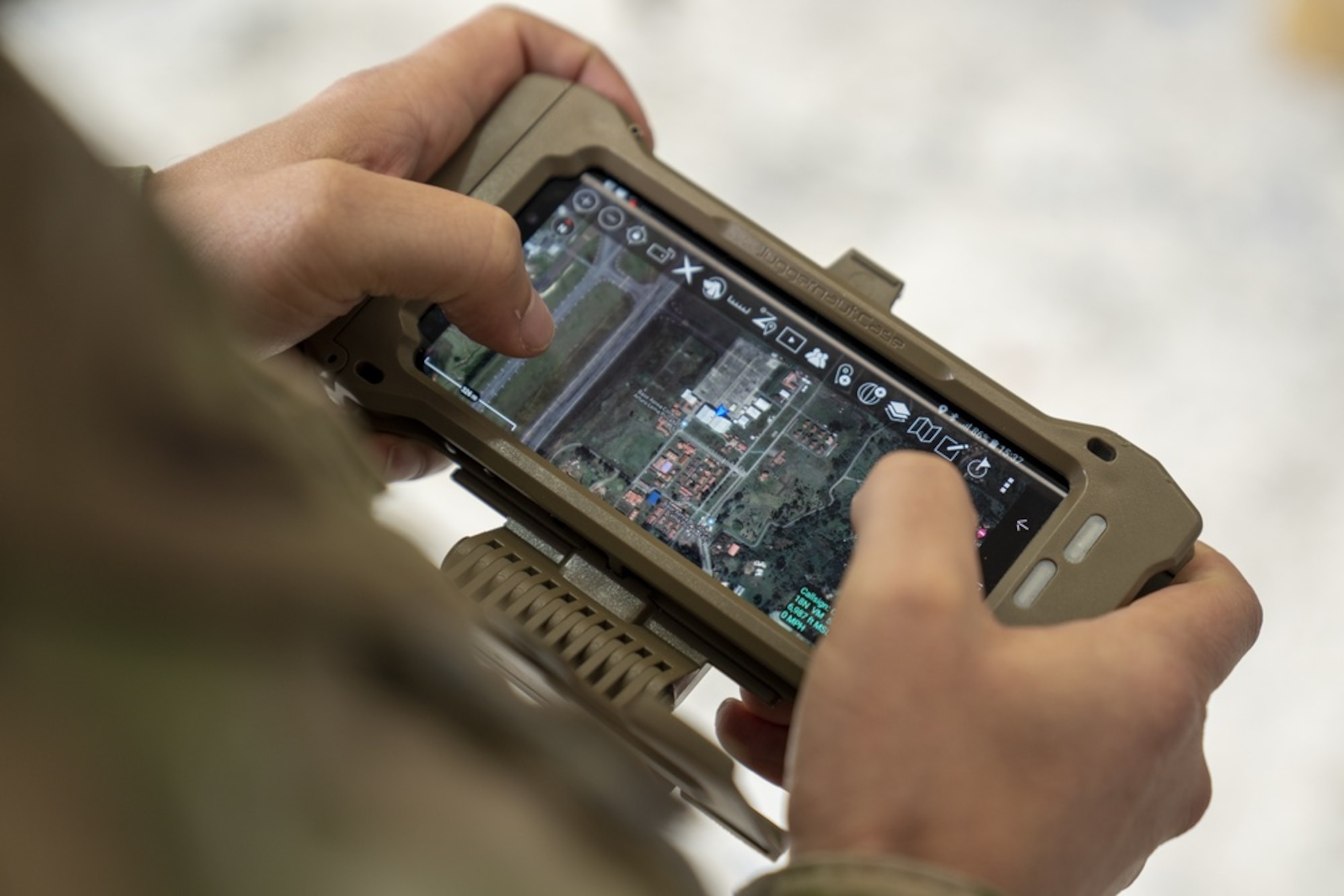A cell phone linked to the AERONet system displays the real-time locations of personnel, vehicles, and aircraft during the Ángel de los Andes exercise outside of Rionegro, Colombia, in September 2021. Operated by the Quick Reaction Capability Branch at Hanscom Air Force Base, Mass., AERONet is an affordable and commercially secure combat system capable of providing video, voice, chat, and position data to partner nations for under $500,000.