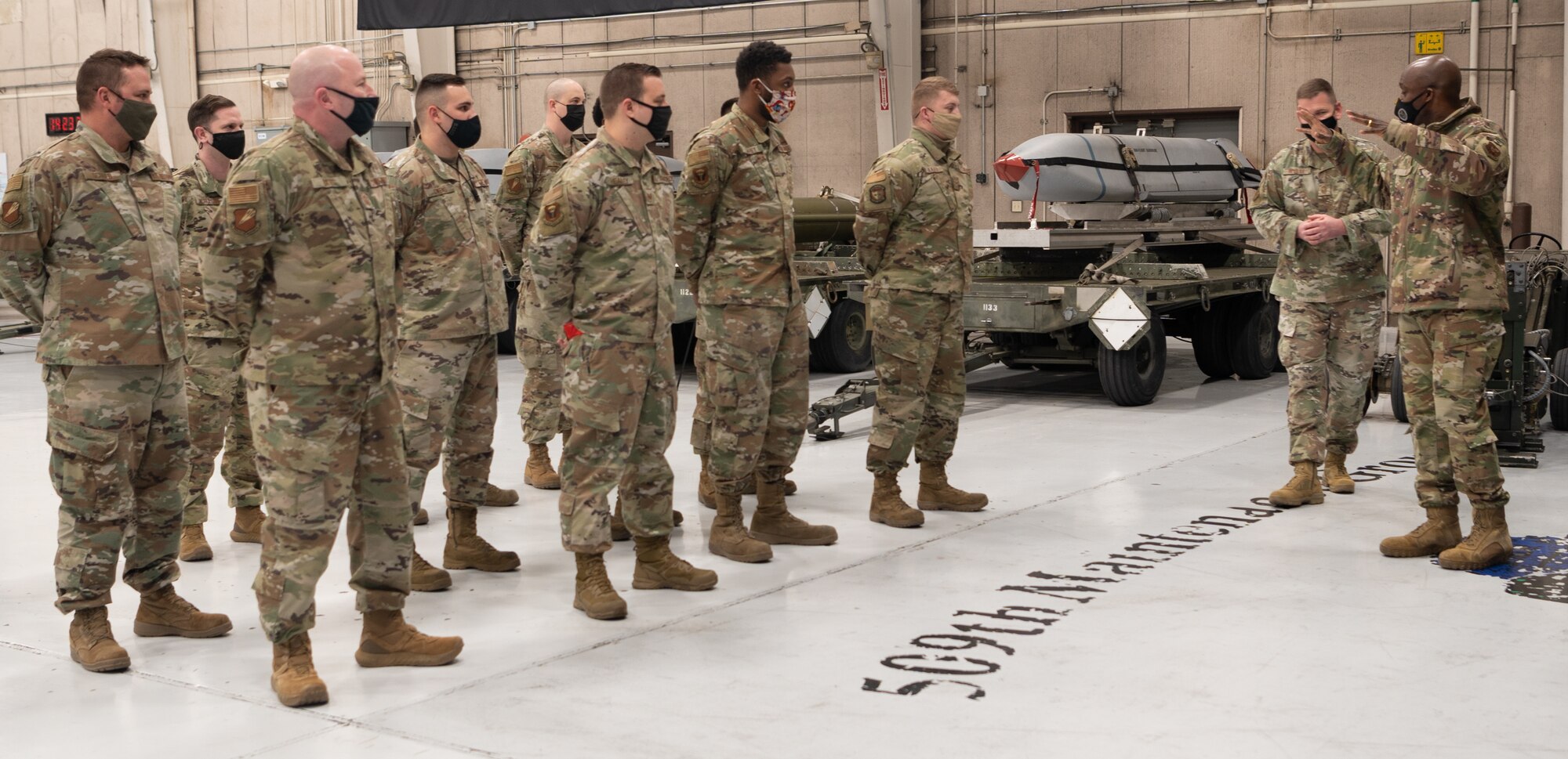 Brig. Gen. Kenyon Bell speaks to weapons Airmen standing in formation.