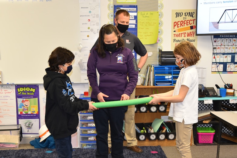Lisa Geist, chief of the Environmental Engineering Section at the U.S. Army Corps of Engineers – Alaska District, explains the concepts of tension and compression using a pool noodle during a National Engineers Week event on Feb. 23 at Pacific Northern Academy in Anchorage.