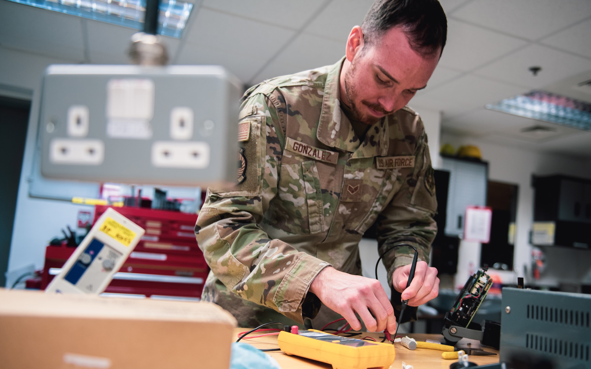 Airman repairs medical equipment.