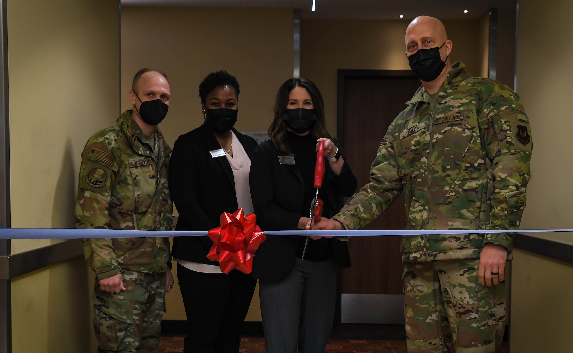 U.S. Air Force Brig. Gen. Josh Olson, 86th Airlift Wing commander, right, and Heidi Payton, 786th Force Support Squadron assistant general manager, second from right, cut the ribbon at a new temporary lodging facility at Ramstein Air base, Germany, Feb. 17, 2022. The TLF allows for an increased capacity of military families to stay on base when they move here from another duty station, while they look for permanent housing. (U.S. Air Force photo by Airman 1st Class Jared Lovett)