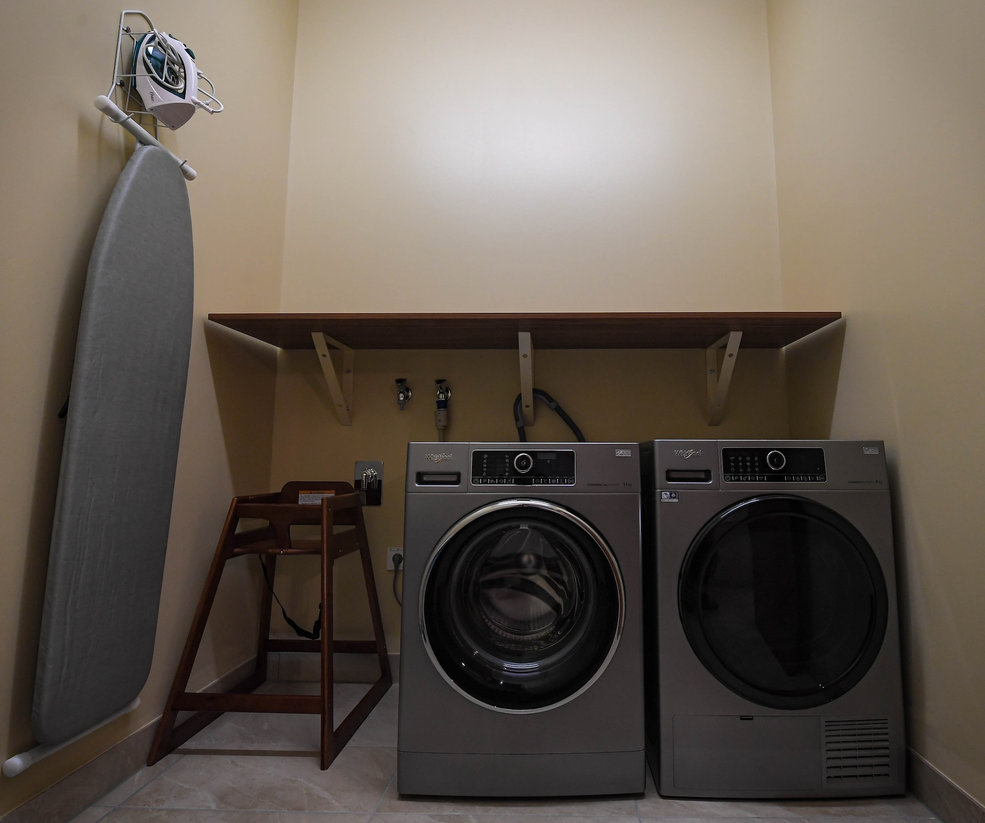 A laundry room furnished with a washer, dryer and ironing board is ready for use at a new temporary lodging facility at Ramstein Air Base, Germany, Feb. 23, 2022. The TLF offers 70 two-bedroom family-units with a fully furnished kitchen, bathroom and underfloor-heating, as well as an elevator. (U.S. Air Force photo by Airman 1st Class Jared Lovett)