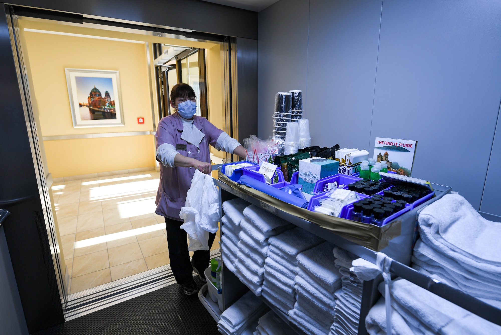 Anette Gross, 786th Force Support Squadron housekeeping supervisor, rolls a trolley onto an elevator at a new temporary lodging facility at Ramstein Air Base, Germany, Feb. 23, 2022. The TLF offers guests the convenience of two elevators so they can easily bring luggage to the upper floors instead of having to use the stairs. (U.S. Air Force photo by Airman 1st Class Jared Lovett)