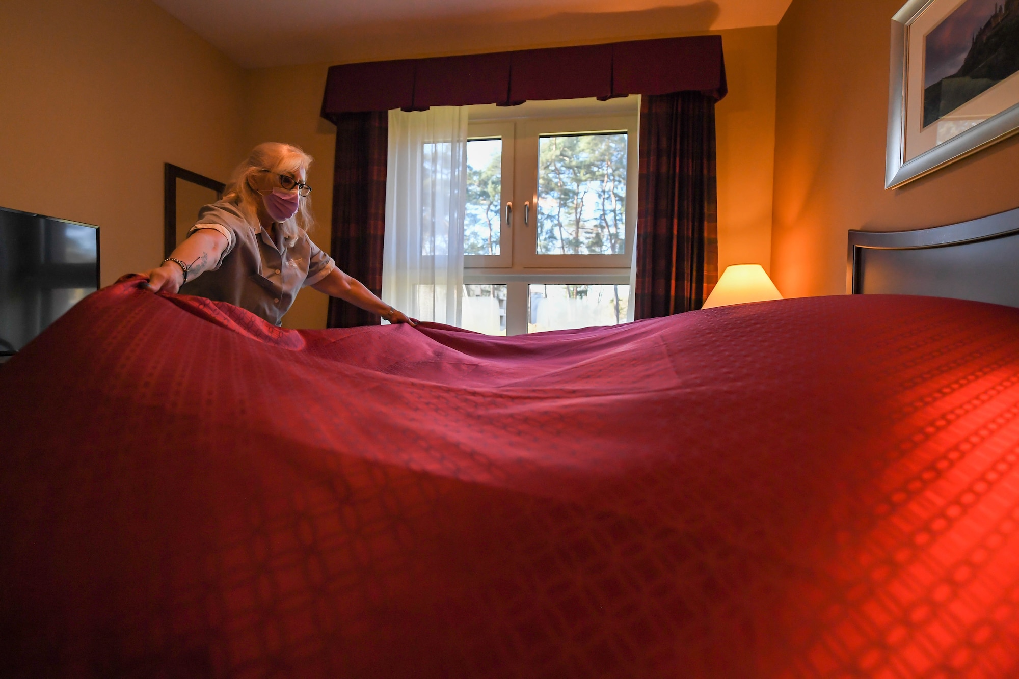 Christiane Schafer, 786th Force Support Squadron housekeeper, makes up a bed at a new temporary lodging facility at Ramstein Air Base, Germany, Feb. 23, 2022. The TLF offers 70 two-bedroom family-units with a fully furnished kitchen, bathroom and underfloor-heating, as well as an elevator. (U.S. Air Force photo by Airman 1st Class Jared Lovett)