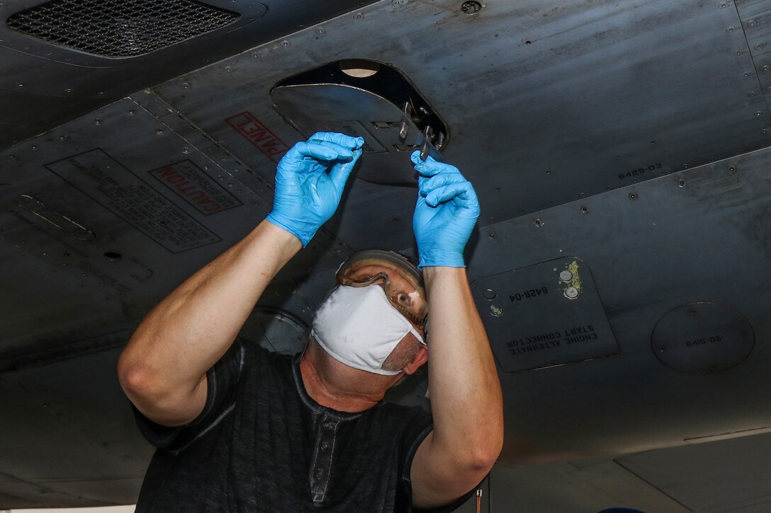 Worker works on aircraft.